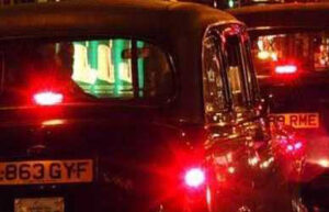 London black cabs at night.