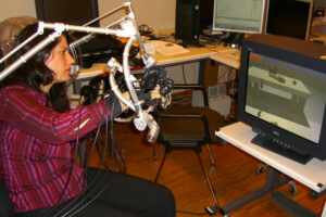 Using the Haptic Workstation I try, generally unsuccessfully, to pick up objects from the virtual table.